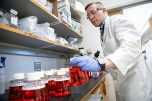 Researcher Jacob Yount works with new viral transport media for COVID-19 test kits